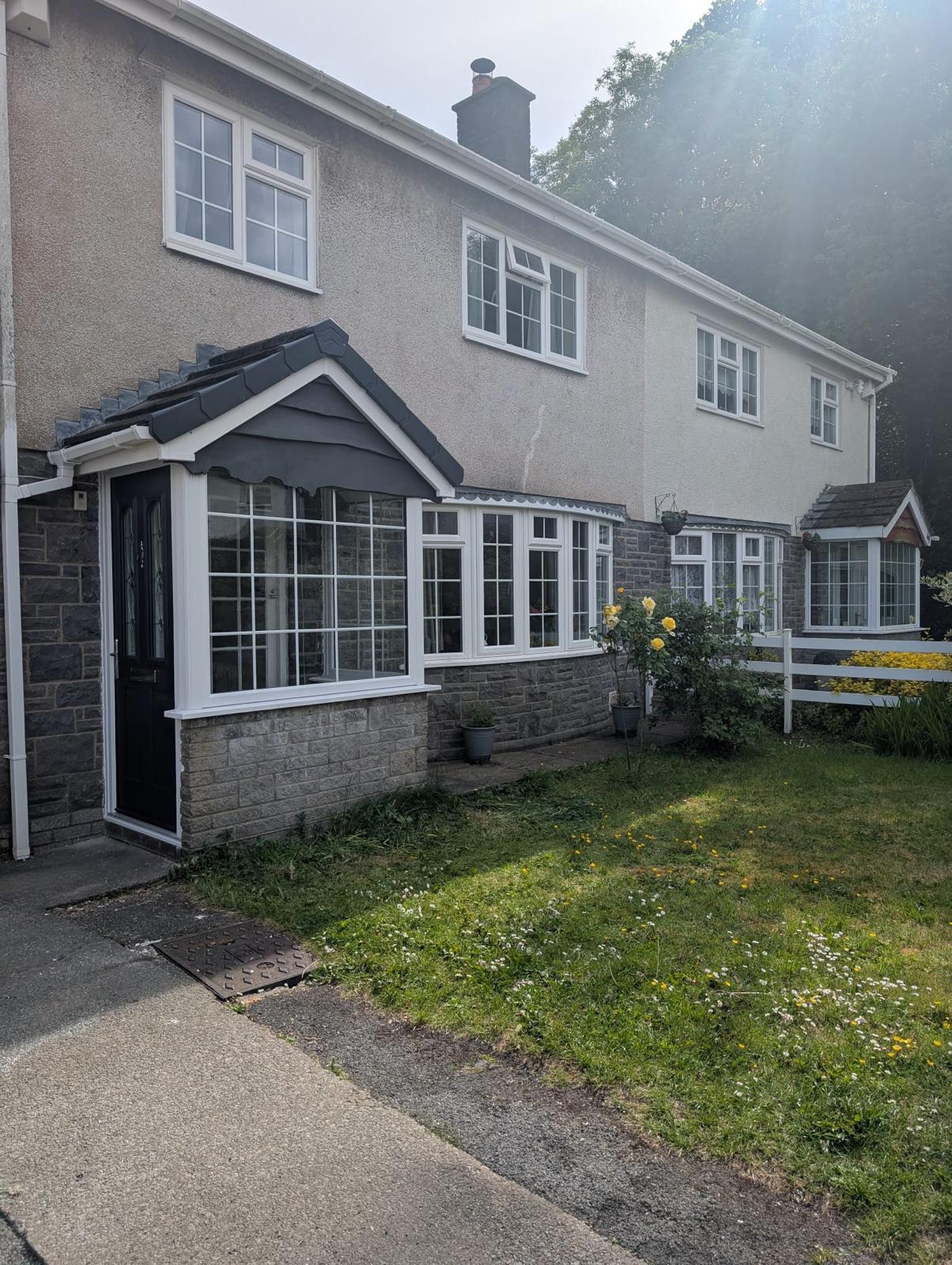 White uPVC conservatory extension on a South Wales home exterior