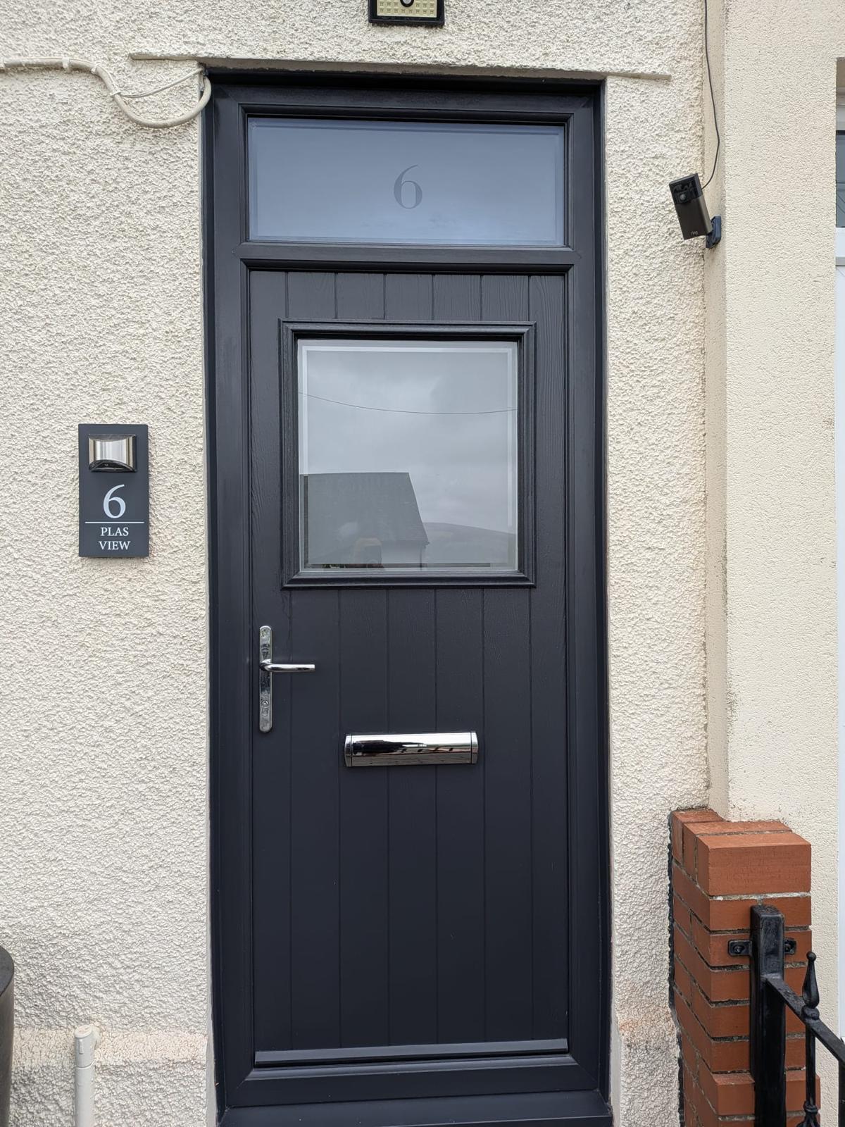 Contemporary composite front door with decorative glazing
